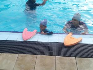 a woman and a child in a swimming pool at Ice mango homestay Badulla in Badulla