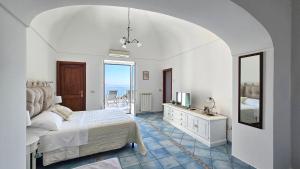 a bedroom with a bed and a sink and a mirror at Al Poggio Antico in Amalfi
