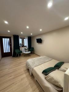 a bedroom with a bed and a table and chairs at Studio design in Beaune