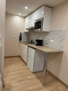 a small kitchen with a counter and a microwave at Studio design in Beaune +5 photos