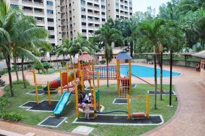 a playground at a resort with a pool at Putra Villa Short Stay Apartment KL in Kuala Lumpur