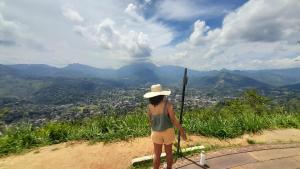 a woman standing on a hill looking at the mountains at Ice mango homestay Badulla in Badulla +11 photos