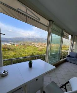 a room with a white table and a large window at Ioanian Évasion in Vlorë