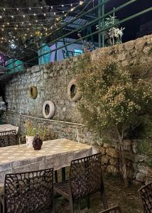 a table with chairs and a stone wall at Stay Maasa Resort in Shivpuri +13 photos