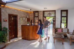 a man and a woman standing in a living room at Palma Rosa Hotel in Kemer