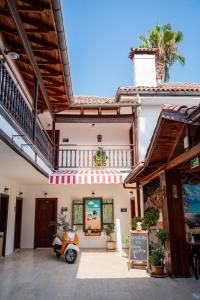 a scooter parked in front of a building at Palma Rosa Hotel in Kemer