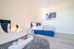 a bedroom with two beds with babies on top of it at 3 Bedroom House in Rishton by Eason Stays, Great Location Near Shops & Transport in Rishton