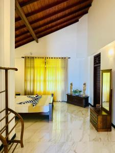 a bedroom with a bed and a chair in it at Sky Palace Hikka in Hikkaduwa