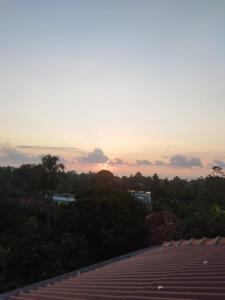a view of the sunset from the roof of a building at Sky Palace Hikka in Hikkaduwa