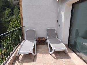 two white chairs sitting on a balcony at Villa Cayetana in Jávea +25 photos