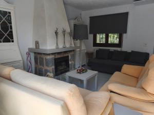 a living room with a couch and a fireplace at Villa Cayetana in Jávea