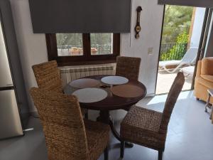 a dining room with a table and chairs and a window at Villa Cayetana in Jávea