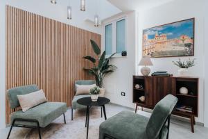 a living room with two chairs and a table at Saffi Suites in Noto