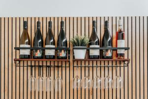 a bunch of bottles of wine on a wall at Saffi Suites in Noto +47 photos