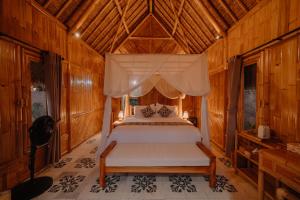 a bedroom with a bed with a canopy at Bambu Teras Viewpoint in Karangasem +10 photos