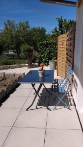 a blue table and chairs on a patio at Chez Sophie, au calme, climatisé, proche d'Aix-les-bains in Grésy-sur-Aix +1 photo