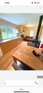 a kitchen and living room with a wooden table at Stickens Apartment in Naas +5 photos