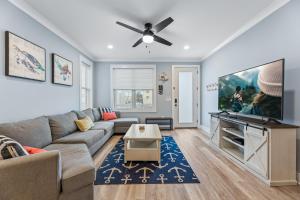 a living room with a couch and a flat screen tv at Cozy Shoregri La! - Beach block! in Seaside Heights