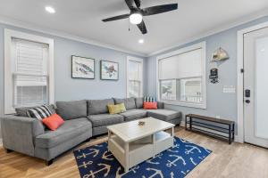 a living room with a couch and a table at Cozy Shoregri La! - Beach block! in Seaside Heights
