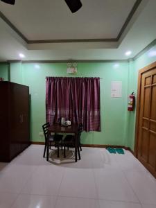 a dining room with a table and a window at JMM Guest House in Panglao Island