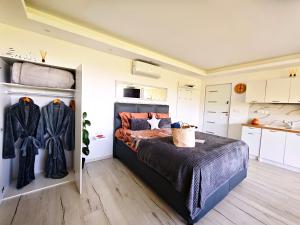 a bedroom with a bed and a kitchen at Private wellness with panoramic view, sauna & jacuzzi in Maribor