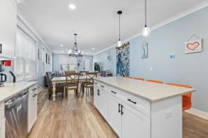 a kitchen and dining room with a dining table at Cozy Shoregri La! - Beach block! in Seaside Heights +22 photos