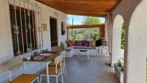 a living room with a table and a couch at Lingo garden house in Nea Irakleia