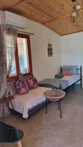 a bedroom with two beds and a table at Lingo garden house in Nea Irakleia