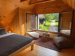 a bedroom with a bed and a large window at Soča Village in Soča
