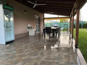 a patio with a table and chairs in a building at Villa Gjorgjevikj in Kumanovo