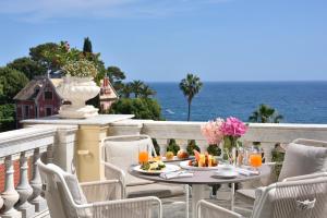 a table with food on a balcony with the ocean at Imperiale Palace Hotel in Santa Margherita Ligure