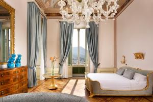 a bedroom with a bed and a chandelier at Imperiale Palace Hotel in Santa Margherita Ligure +139 photos