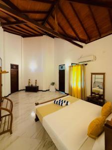 a bedroom with a large bed in a room at Sky Palace Hikka in Hikkaduwa +2 photos