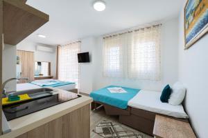 a hospital room with two beds and a sink at Villa Ines in Budva