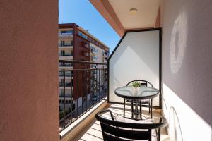 a balcony with a table and chairs on a balcony at Villa Ines in Budva