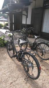two bikes are parked in front of a house at Minpaku Nambu in Koka