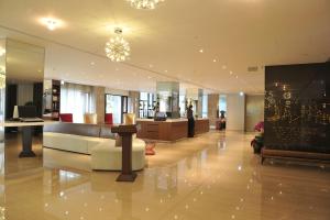 a lobby with a white couch in a building at Kaohsiung International Plaza in Kaohsiung