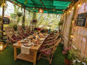 a long wooden table and chairs in a garden at Stendel Villa Fort Road, Leh in Leh