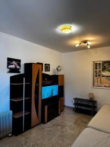a living room with a flat screen tv and a couch at Apartman Tafra1 in Igalo