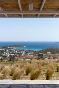 a view of the ocean from a house at Stunning View Sarakiniko Villa in Agios Petros +25 photos