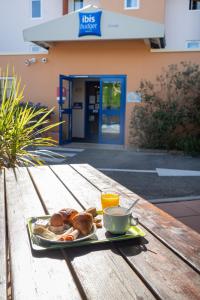 a tray of food on a table with a plate of food at ibis budget Orange Centre in Orange