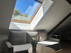 a living room with a couch and a window at Haus Lilium-Gemütliche Dachgeschoss Wohnung in Freudenstadt