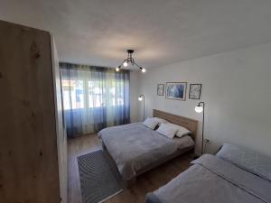 a bedroom with two beds and a window at Apartman Roko in Gospić