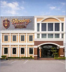 a hotel with a sign on the front of it at Blessing Hotel Pandan in Halangan