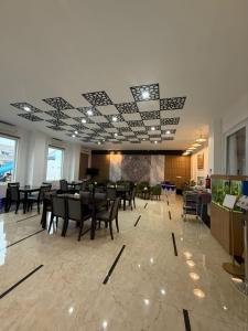 a dining room with tables and chairs in a building at Blessing Hotel Pandan in Halangan