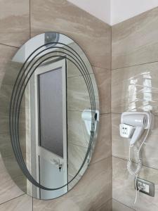 a bathroom with a mirror and a sink at Bujtina Valgent in Berat