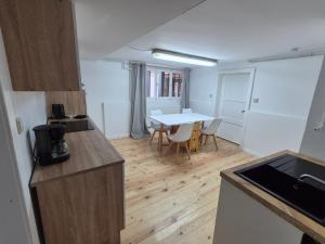a kitchen and dining room with a table and a kitchen and a room with at Fachwerkstube in Witzenhausen