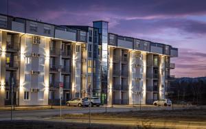a building with two cars parked in front of it at Silver Sunset 26 in Veliko Gradište