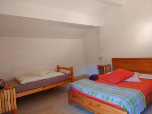 a bedroom with two beds in a room at Auberge de Miélandre in Teyssières