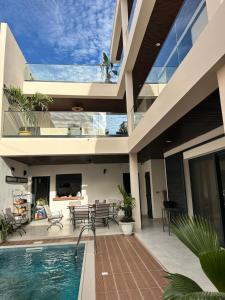 an image of a house with a swimming pool at VillaRama in Saint-Louis